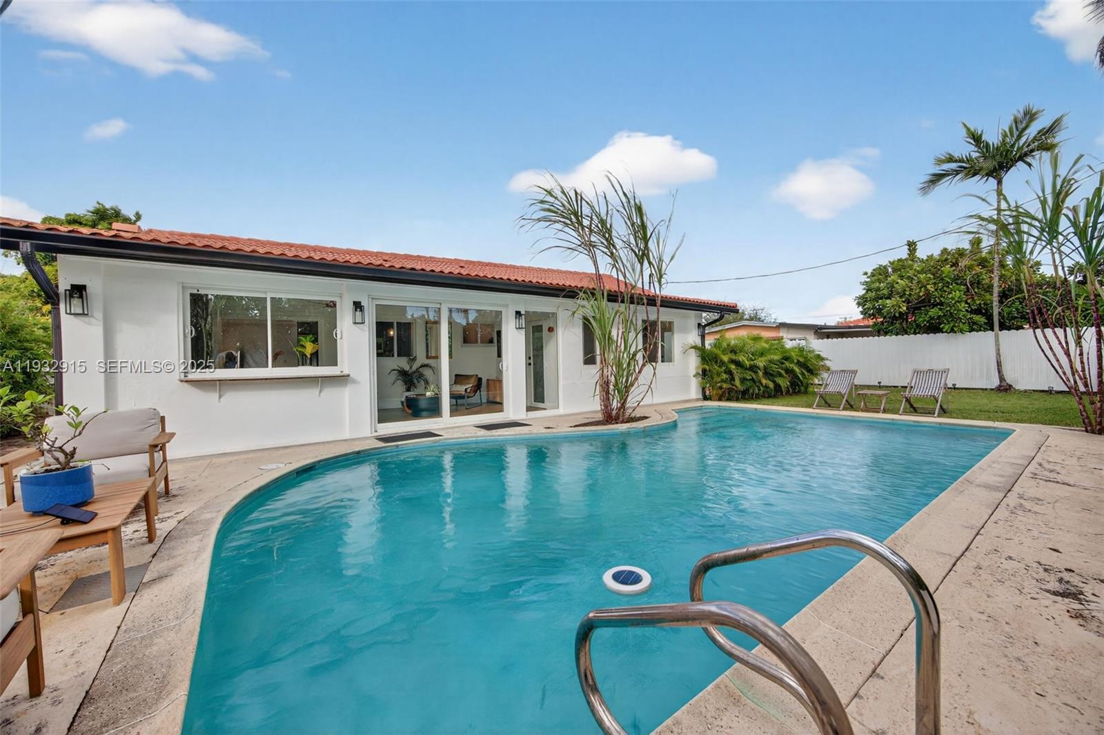 11260 Southwest 48th Street Miami, FL 33165 - Photo 42 of 48 a view of a house with pool and chairs