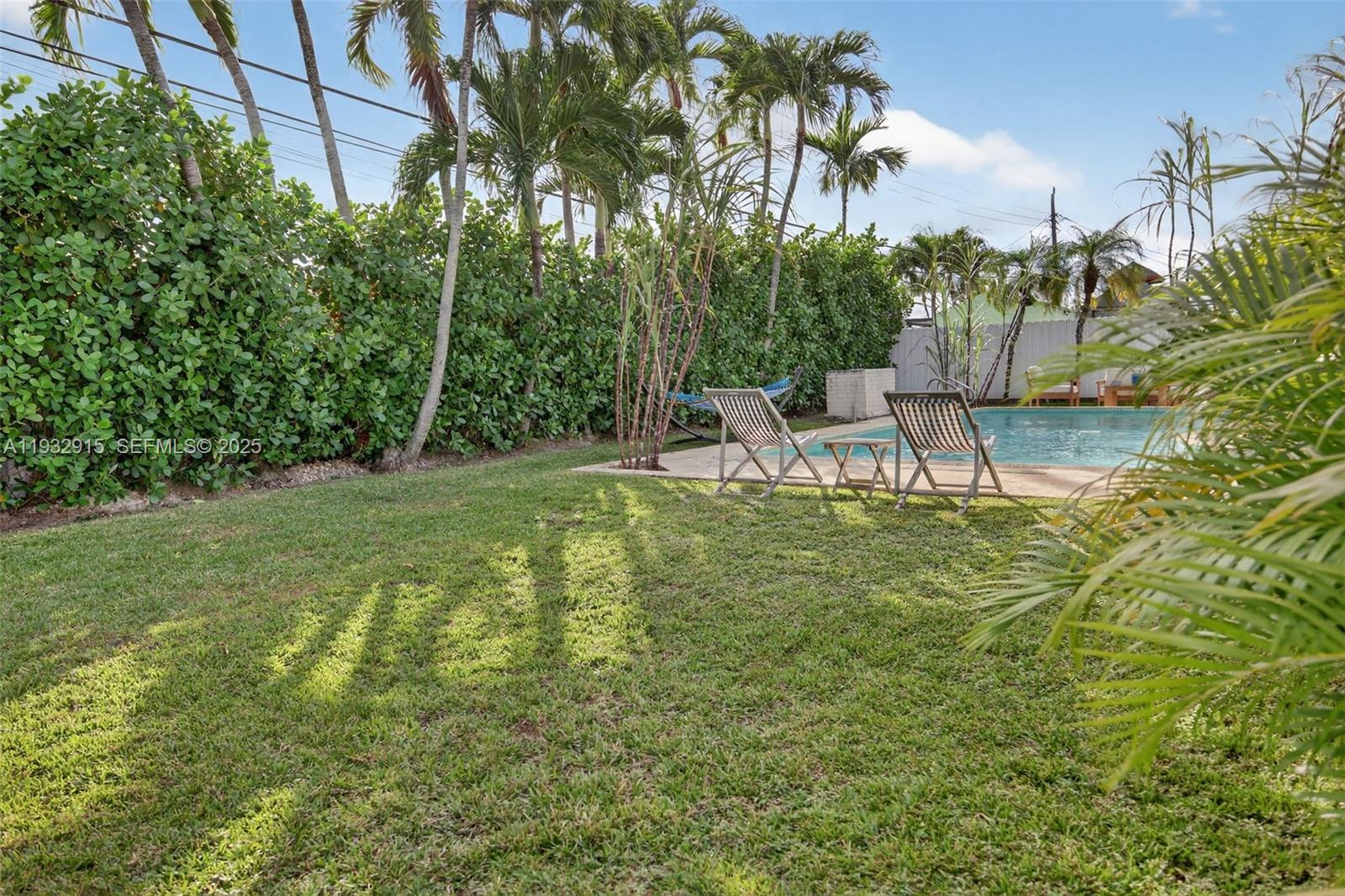 11260 Southwest 48th Street Miami, FL 33165 - Photo 48 of 48 a view of a chairs and table in the garden