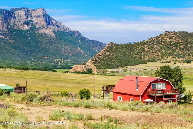 a living room with furniture a window and a chandelier