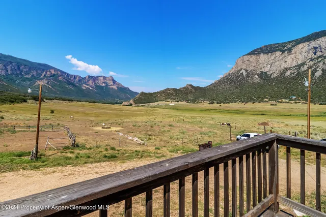 a view of a livingroom with furniture and a fireplace