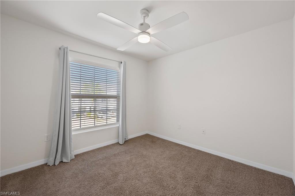 15071 Wildflower Circle Naples, FL 34119 - Photo 16 of 34 an empty room with windows and fan