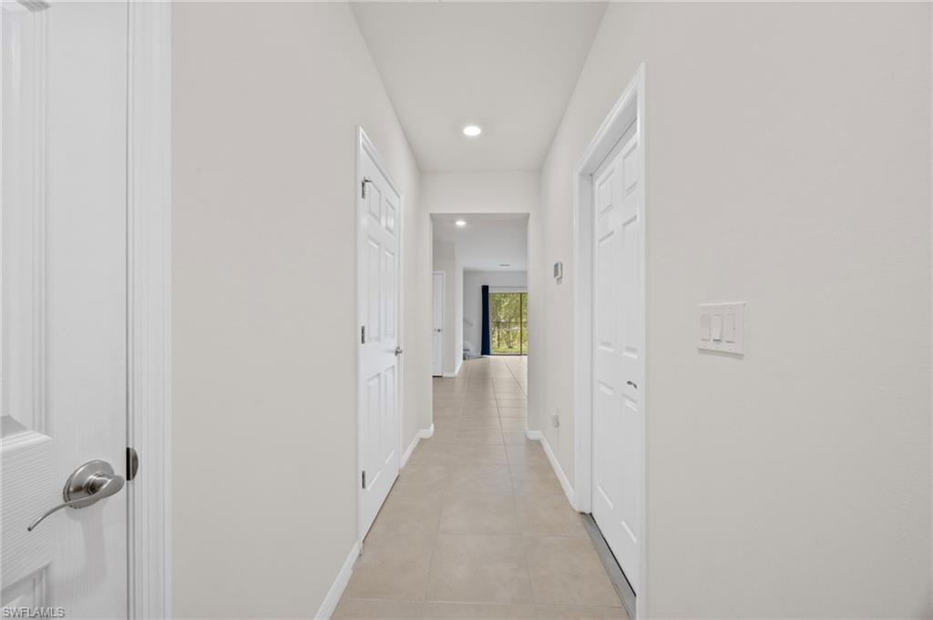 15071 Wildflower Circle Naples, FL 34119 - Photo 21 of 34 a view of a hallway with wooden floor