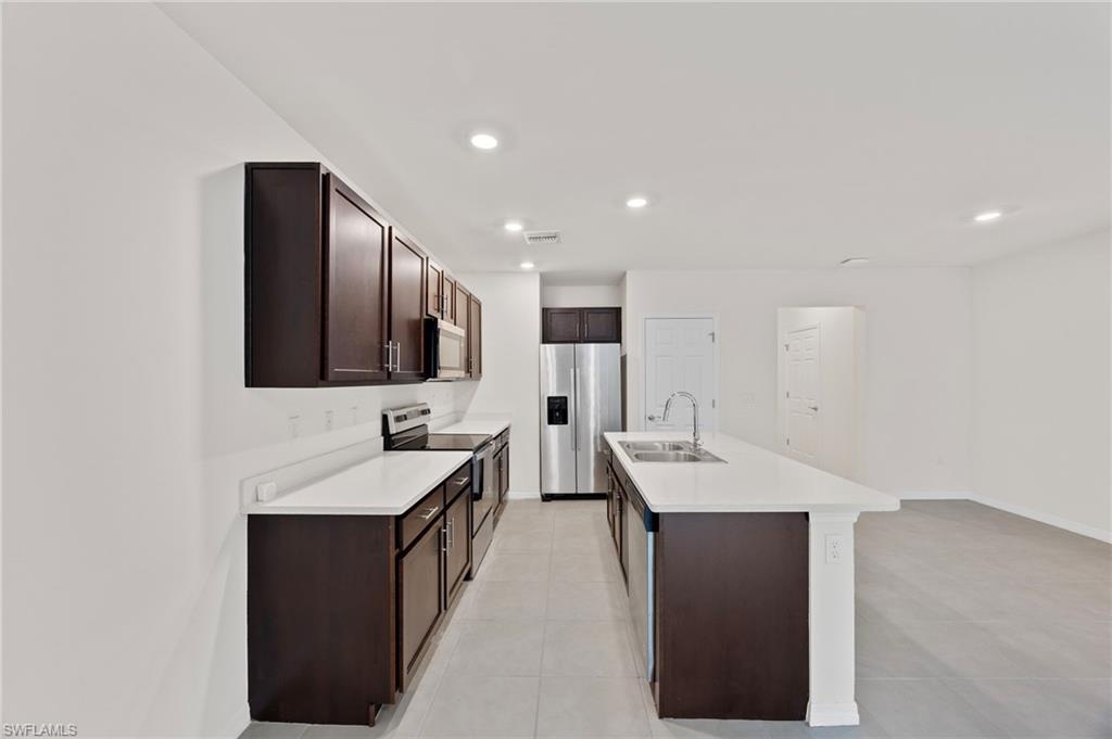 15071 Wildflower Circle Naples, FL 34119 - Photo 5 of 34 a bathroom with a sink and a mirror