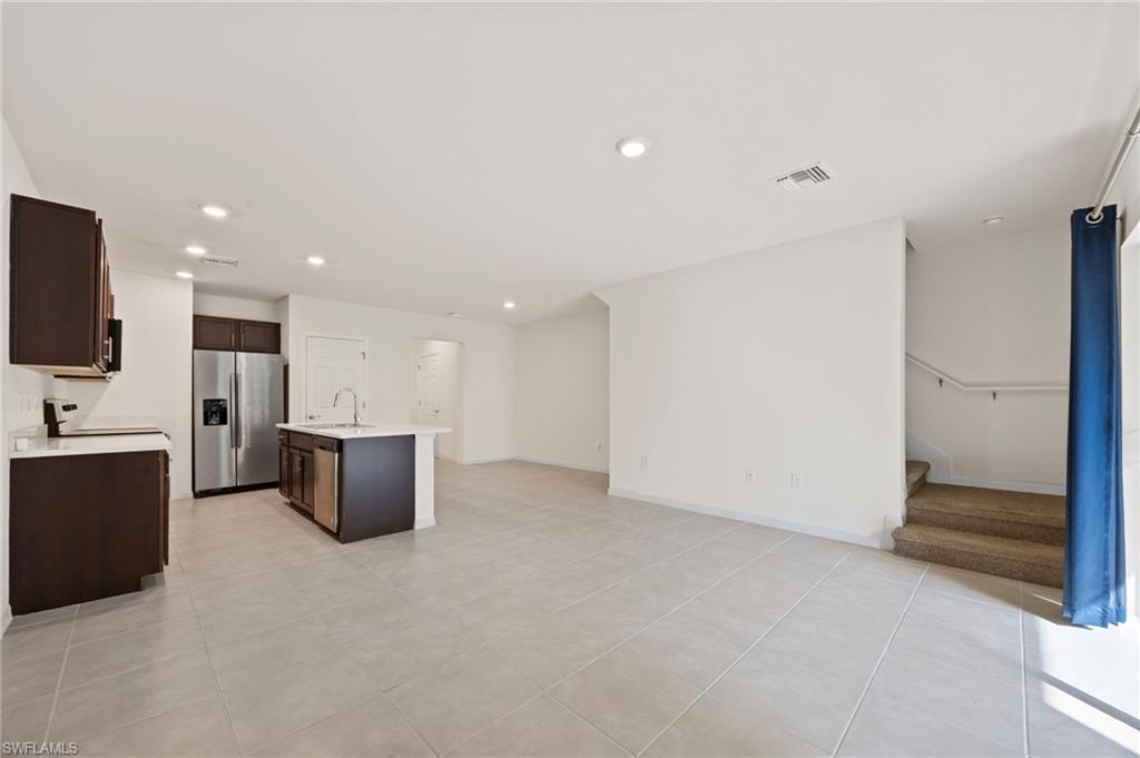 15071 Wildflower Circle Naples, FL 34119 - Photo 34 of 34 a view of kitchen with refrigerator stove microwave and cabinets