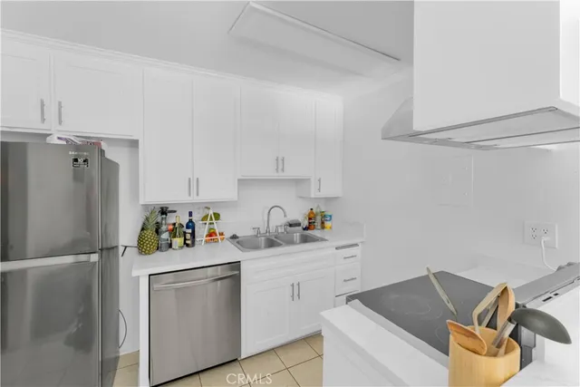 a kitchen with a refrigerator and sink