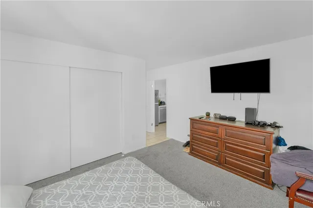 a room with a bed and a flat screen tv