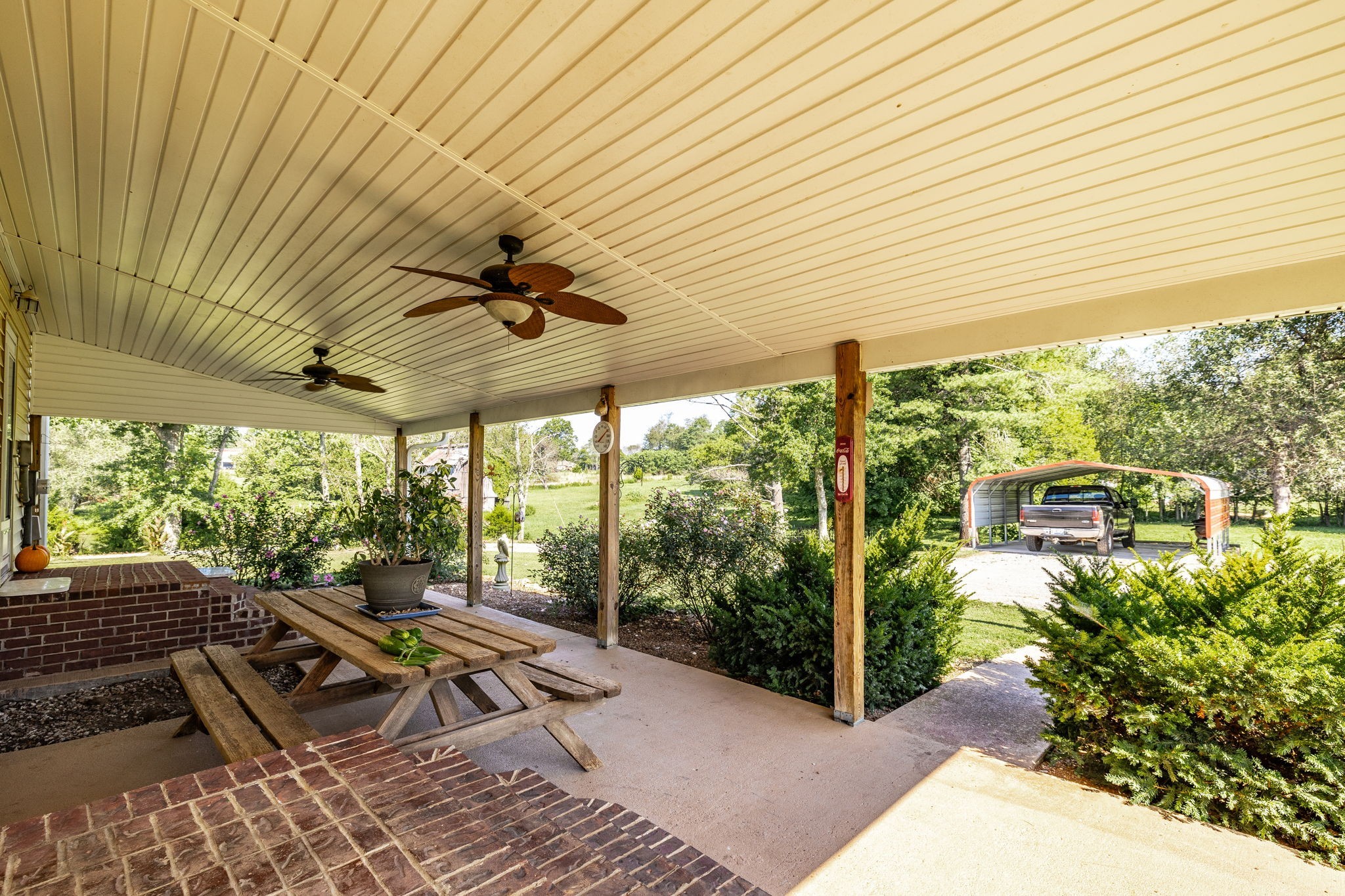 475 Fowler Ford Road Portland, TN 37148 - Photo 51 of 100 a view of a patio with table and chairs and wooden floor