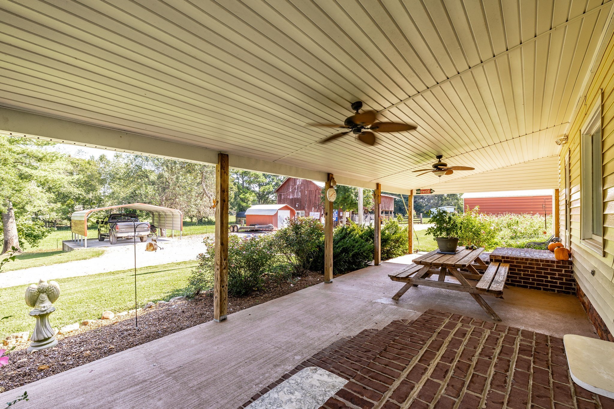475 Fowler Ford Road Portland, TN 37148 - Photo 53 of 100 a view of a patio with table and chairs potted plants with wooden floor and fence