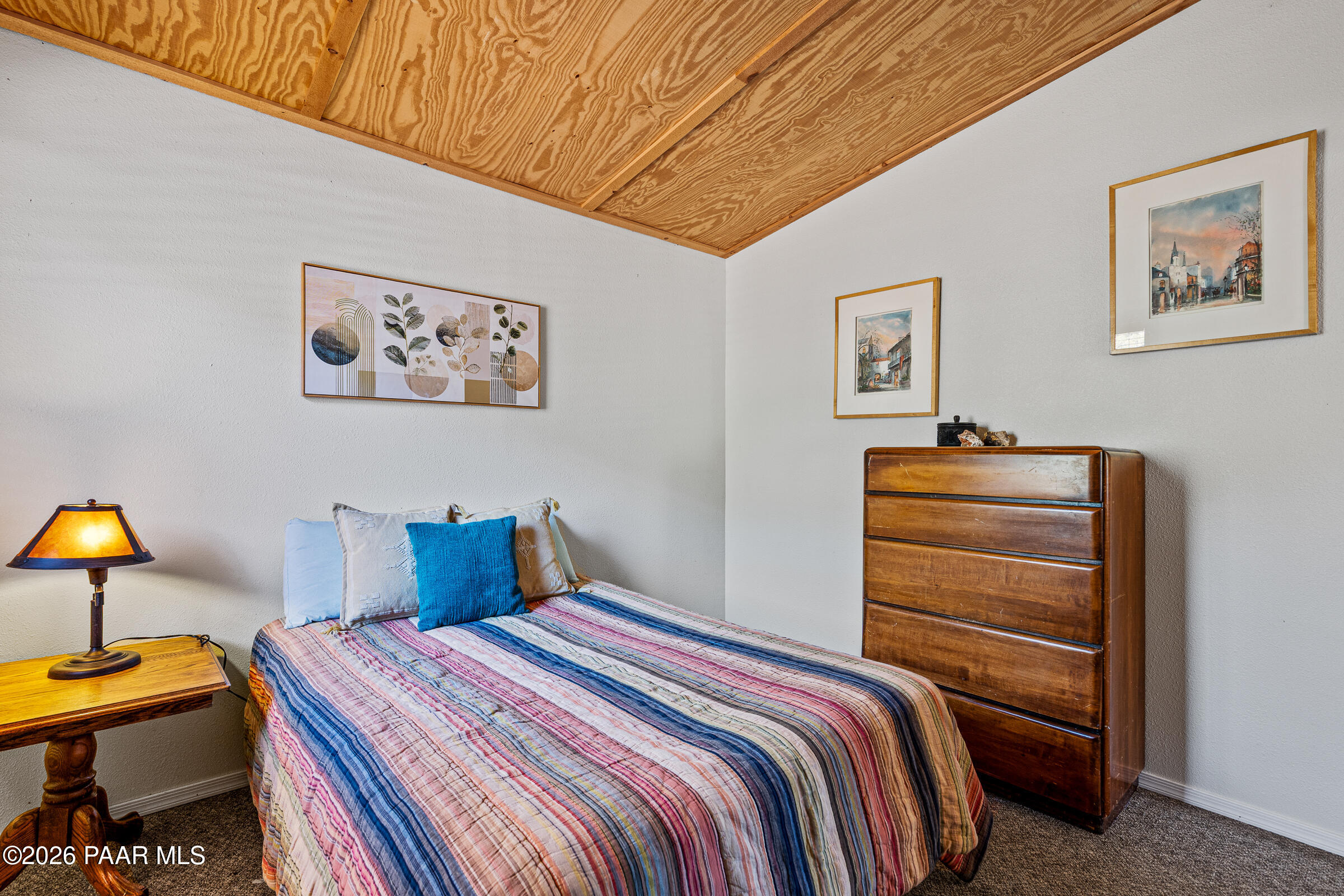 33749 West Whiskey River Road, Unit 21 Seligman, AZ 86337 - Photo 19 of 41 a bedroom with a bed and a lamp on table