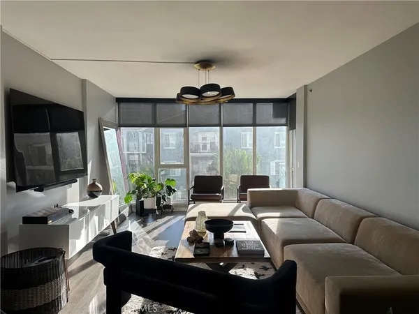 a living room with furniture fireplace and flat screen tv