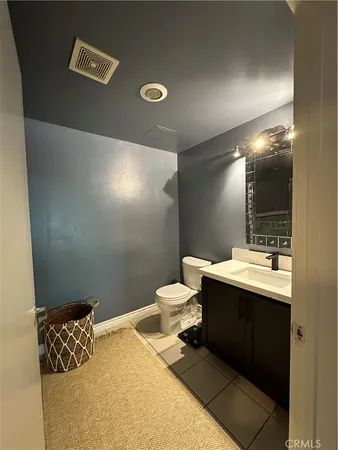 a bathroom with a sink toilet and mirror
