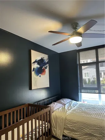 a bedroom with a bed and a painting on the wall