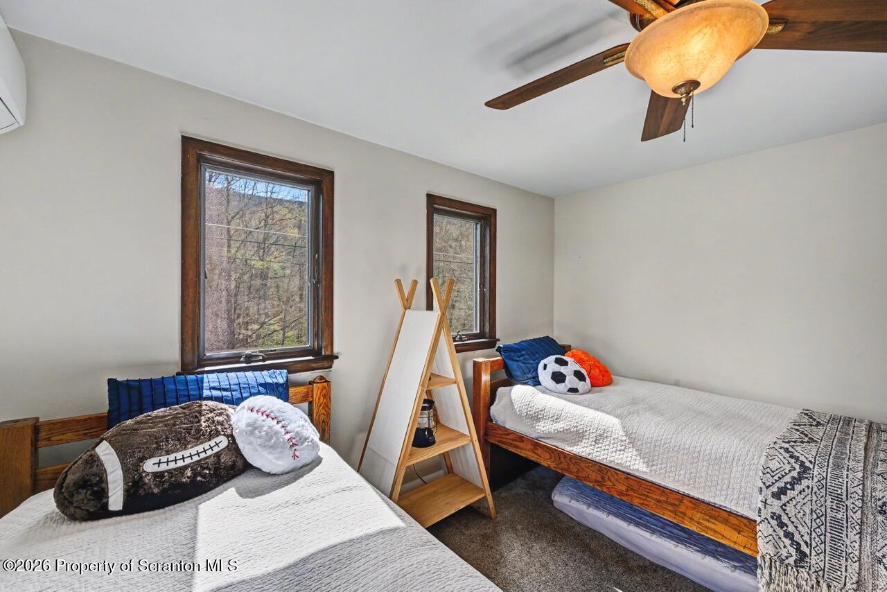 719 Scott Road Clarks Summit, PA 18411 - Photo 28 of 51 a bedroom with a bed and wooden floor