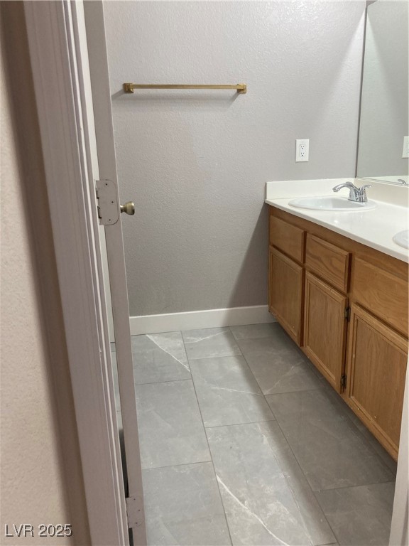 Undisclosed Address Las Vegas, NV 89128 - Photo 20 of 21 Bathroom with marble look tiles, double vanity, an