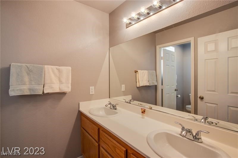 Undisclosed Address Las Vegas, NV 89128 - Photo 3 of 21 Bathroom featuring toilet and double vanity