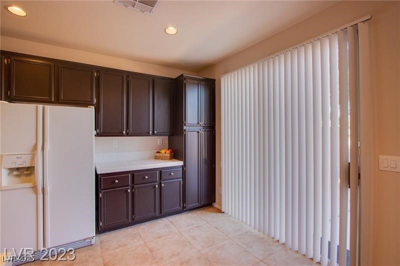 Undisclosed Address Las Vegas, NV 89128 - Photo 6 of 21 Kitchen with white refrigerator with ice dispenser