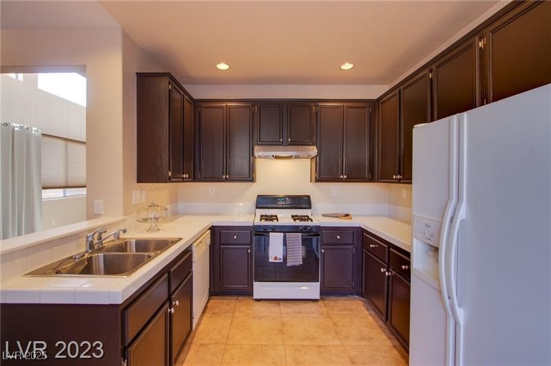 Undisclosed Address Las Vegas, NV 89128 - Photo 7 of 21 Kitchen with white appliances, under cabinet range