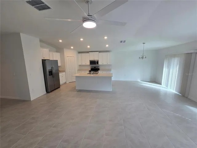 a view of a kitchen with a sink and a refrigerator