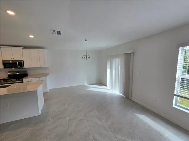 a view of a kitchen with microwave and cabinets