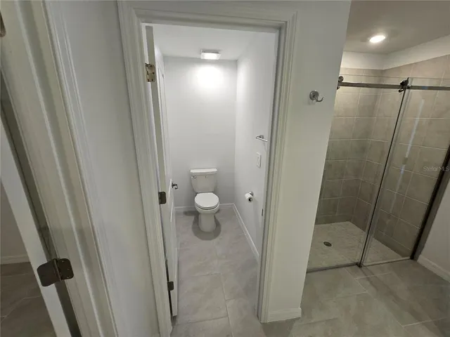 a bathroom with a glass door shower