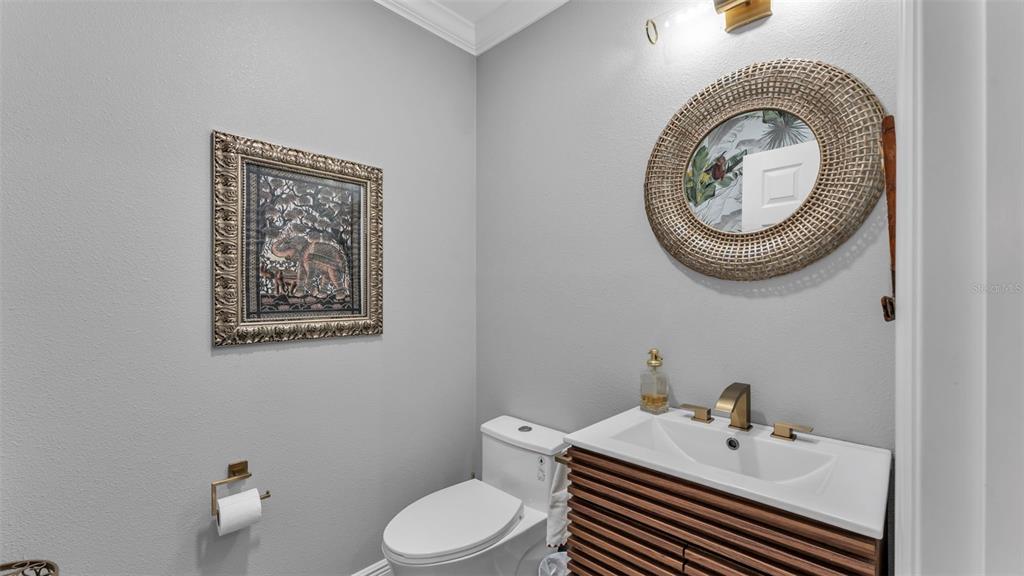 422 Mc Cormick Road Apopka, FL 32703 - Photo 11 of 95 a bathroom with a toilet a sink and a mirror