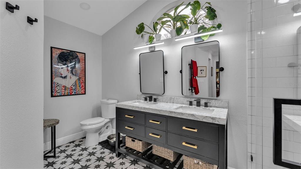 422 Mc Cormick Road Apopka, FL 32703 - Photo 28 of 95 a bathroom with a toilet sink and mirror