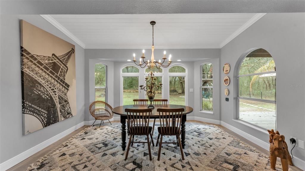 422 Mc Cormick Road Apopka, FL 32703 - Photo 42 of 95 a dining room with furniture a chandelier and a rug