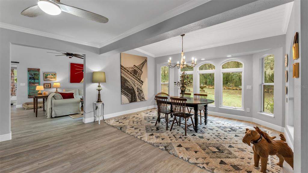 422 Mc Cormick Road Apopka, FL 32703 - Photo 44 of 95 a view of a dining room with furniture window and wooden floor