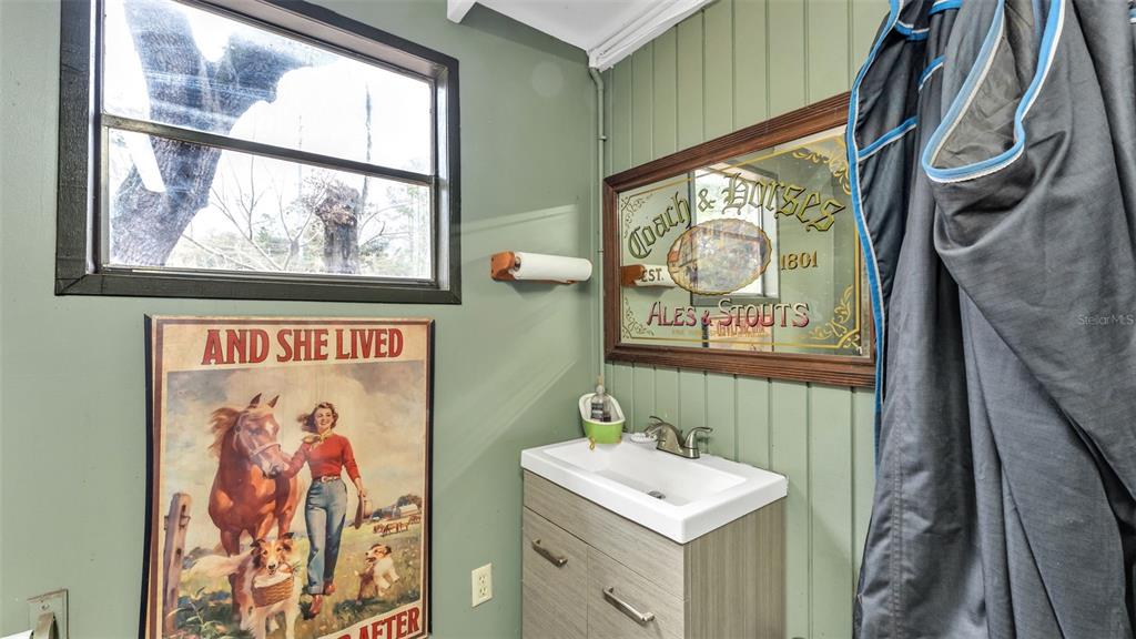 422 Mc Cormick Road Apopka, FL 32703 - Photo 68 of 95 a bathroom with a sink and a painting on the wall