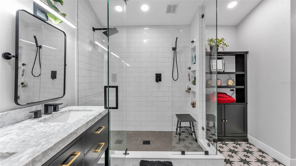 422 Mc Cormick Road Apopka, FL 32703 - Photo 7 of 95 a bathroom with a granite countertop sink a mirror and shower