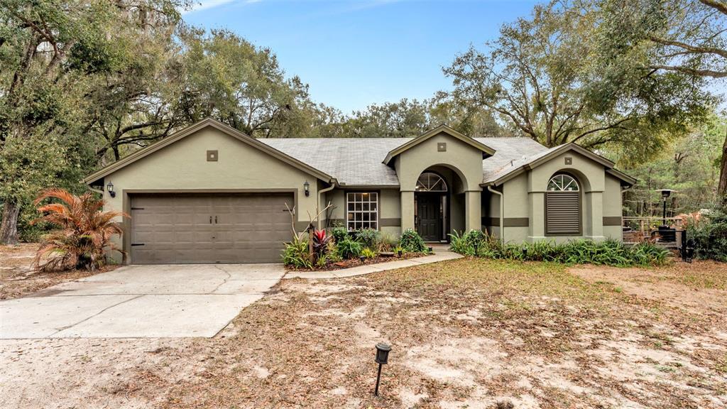 422 Mc Cormick Road Apopka, FL 32703 - Photo 81 of 95 a front view of a house with a yard and garage