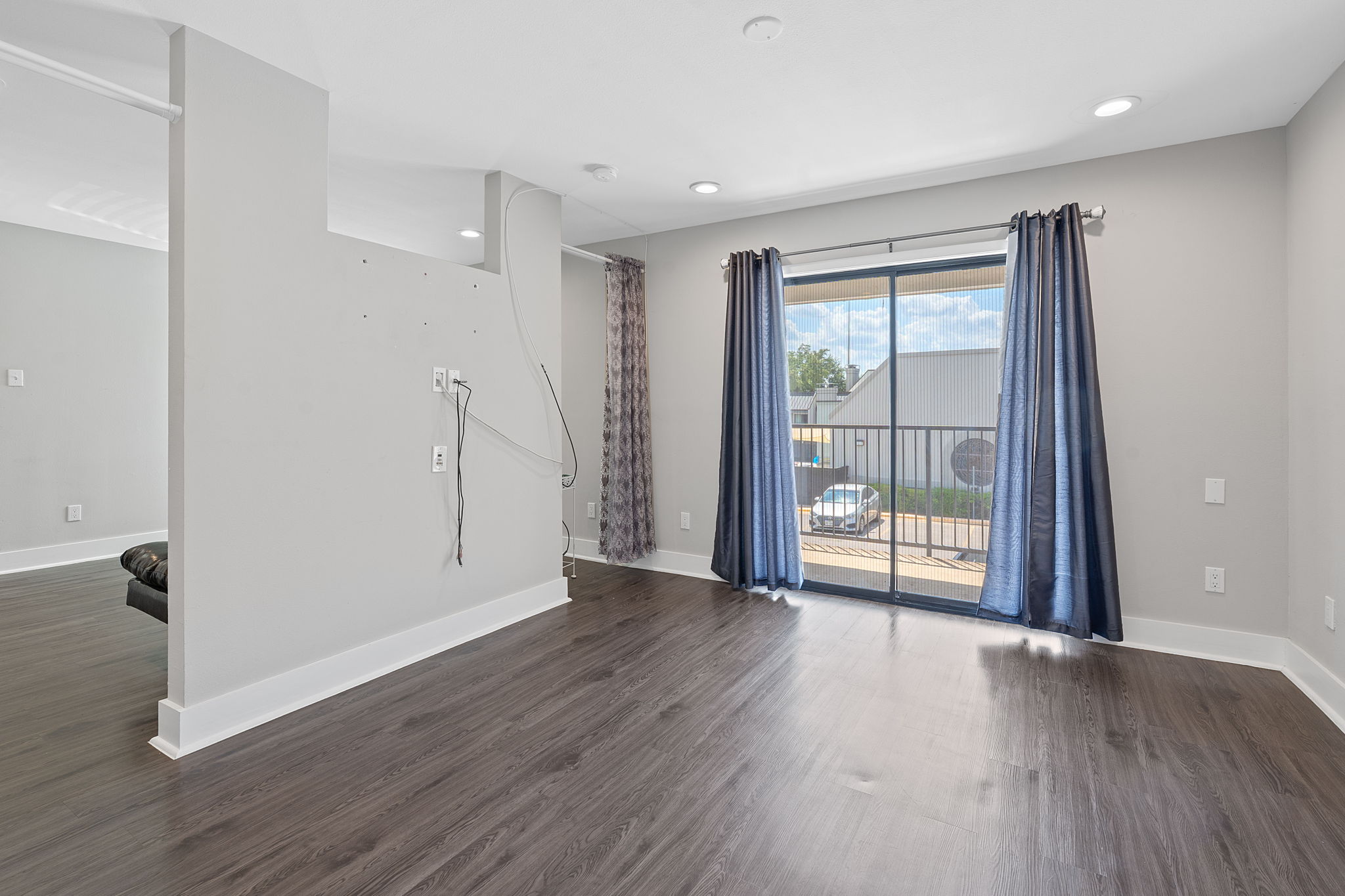 935 La Posada Drive, Unit 254 Austin, TX 78752 - Photo 9 of 18 Unfurnished room featuring dark wood-style floors and recessed lighting