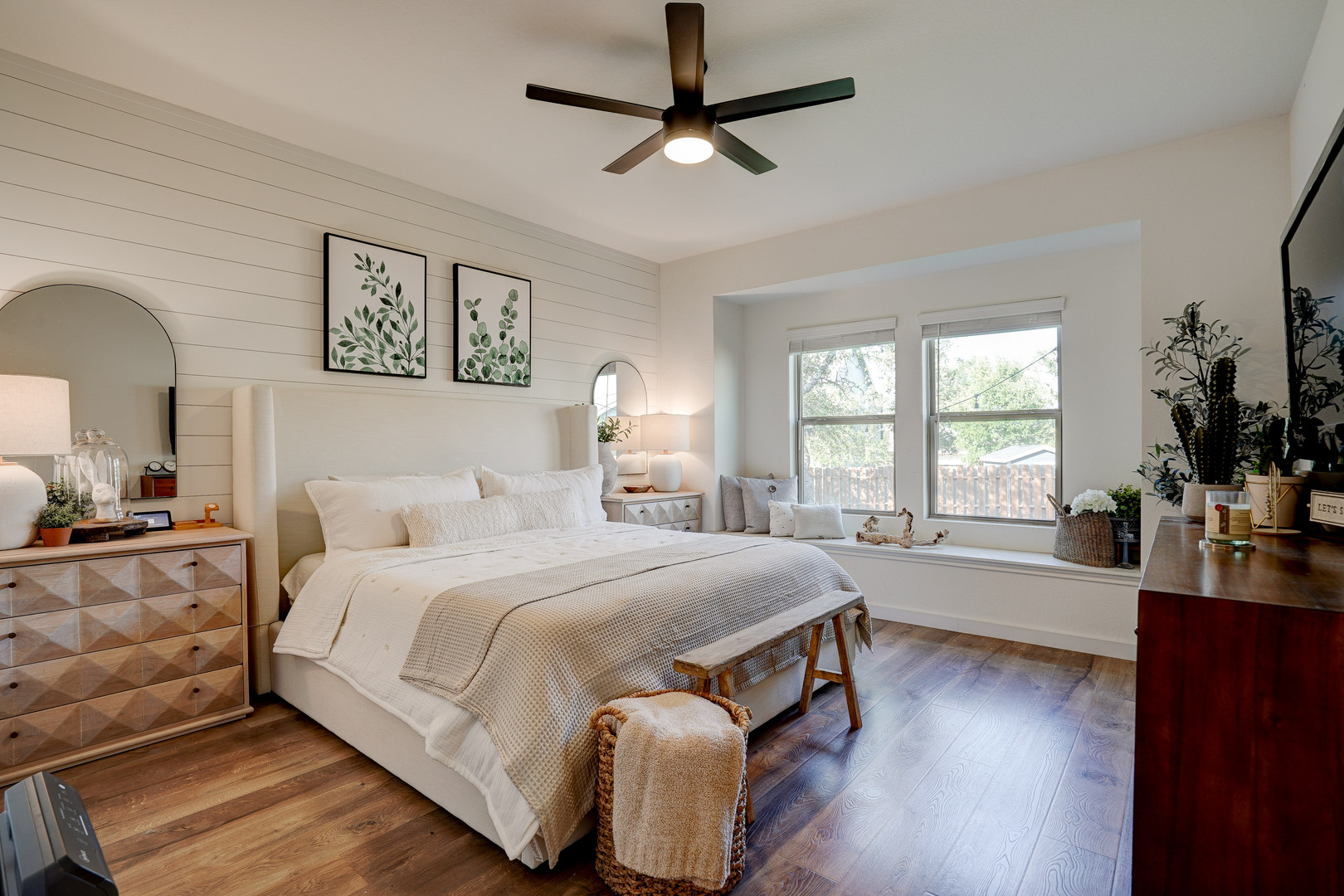 2240 Ringstaff Road Leander, TX 78641 - Photo 14 of 25 Bedroom featuring wood-finish flooring, a decorative shiplap accent wall, and a ceiling fan with integrated lighting