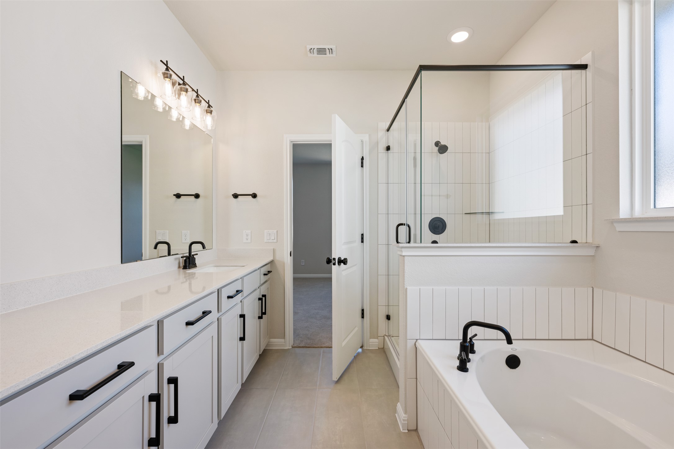 1036 Sienna Bear Road Georgetown, TX 78633 - Photo 11 of 33 a bathroom with a tub sink and mirror