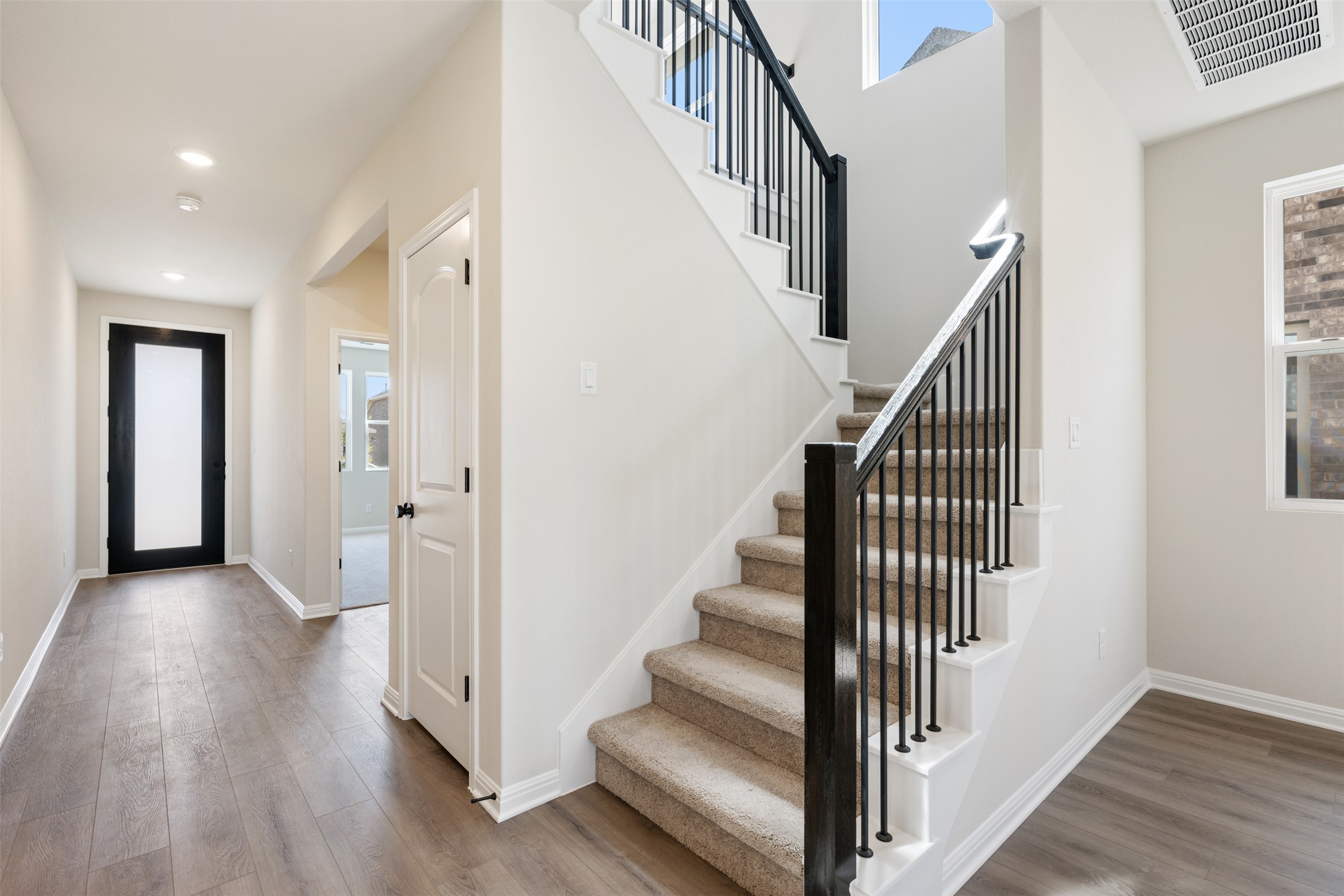 1036 Sienna Bear Road Georgetown, TX 78633 - Photo 12 of 33 a view of a hallway with wooden floor and entryway