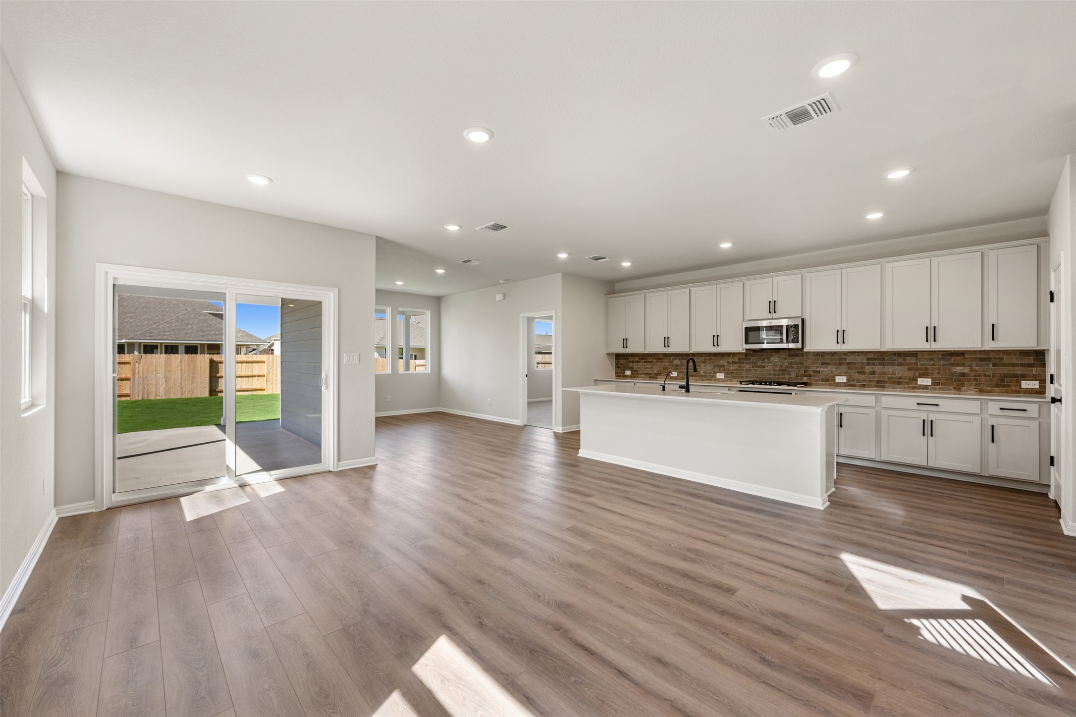 1036 Sienna Bear Road Georgetown, TX 78633 - Photo 23 of 33 a view of large kitchen with a sink and wooden floor
