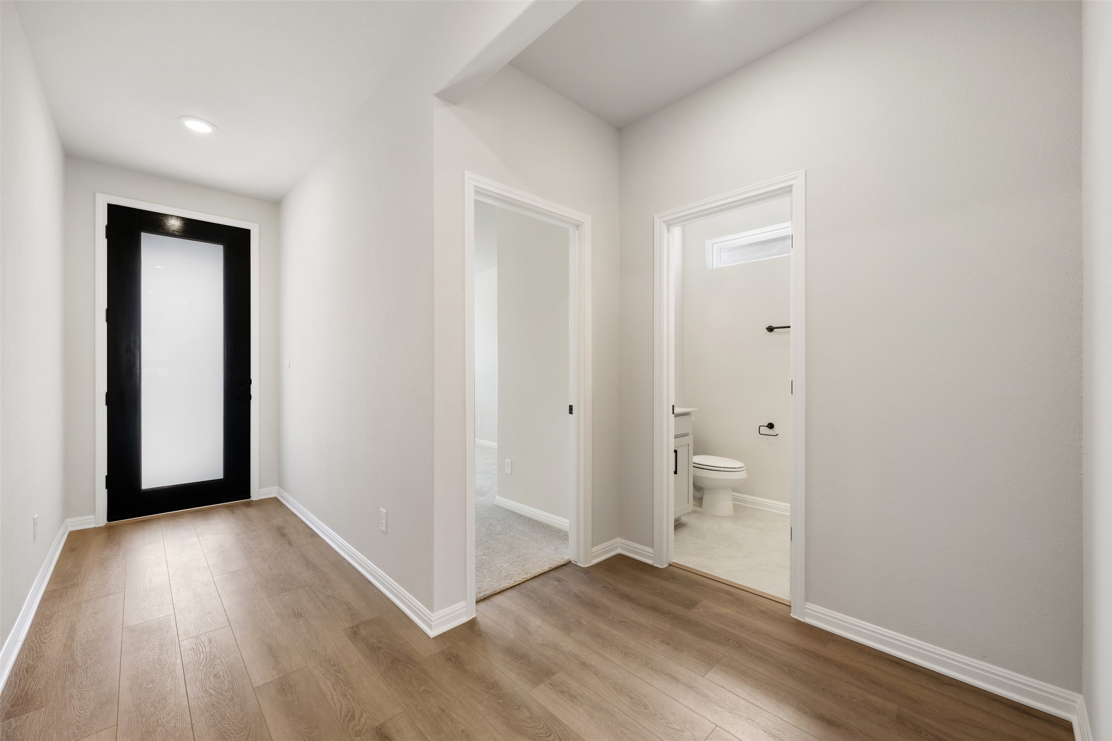 1036 Sienna Bear Road Georgetown, TX 78633 - Photo 26 of 33 a view of an empty room with wooden floor and a window