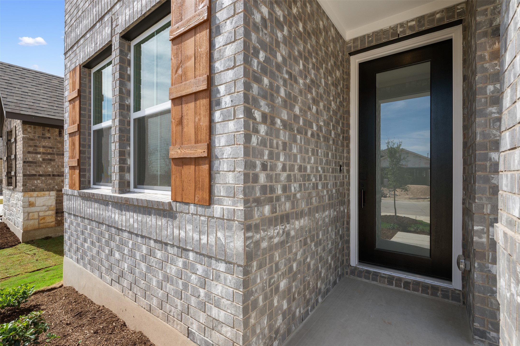 1036 Sienna Bear Road Georgetown, TX 78633 - Photo 32 of 33 a view of a brick house with large windows
