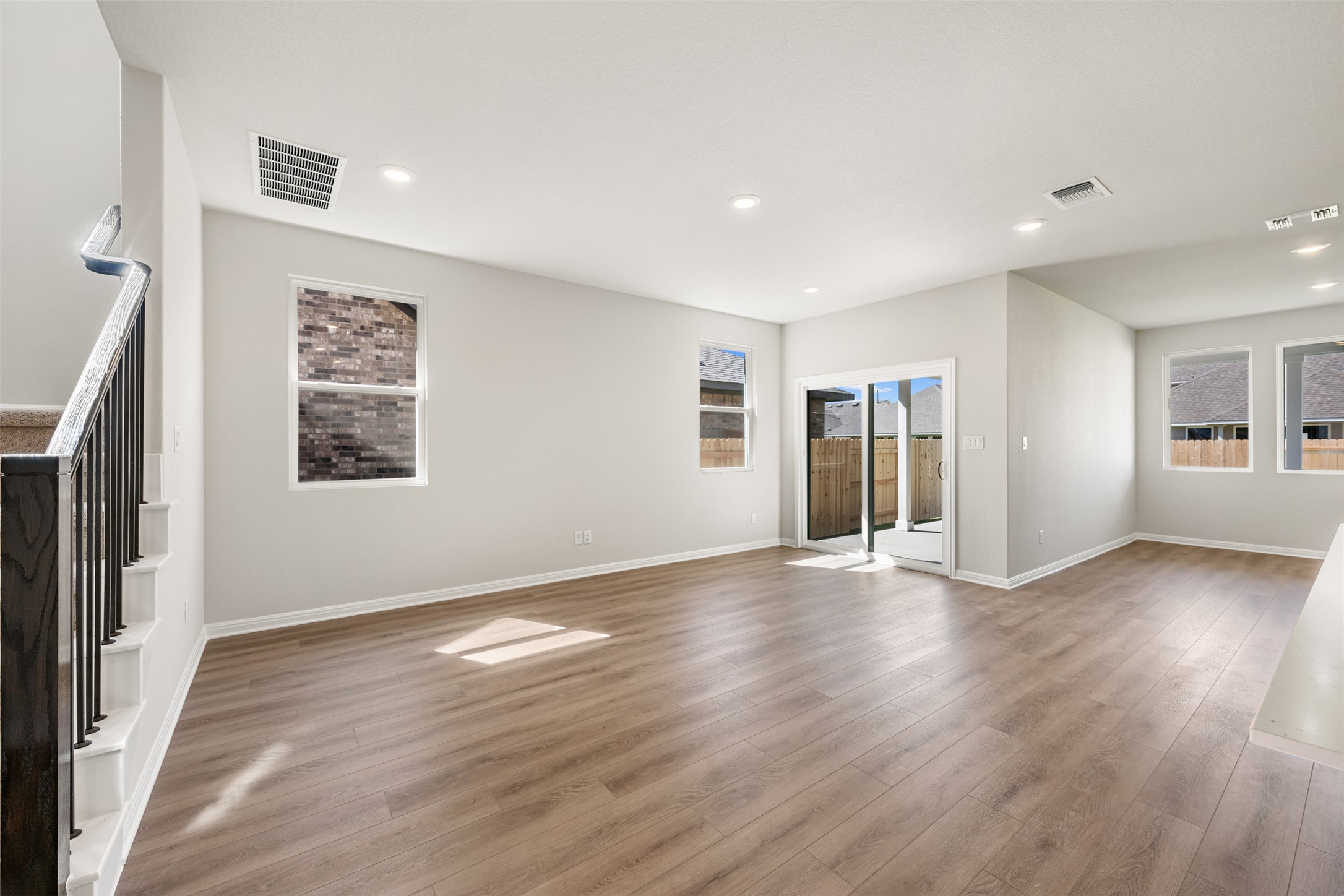 1036 Sienna Bear Road Georgetown, TX 78633 - Photo 5 of 33 an empty room with wooden floor and windows