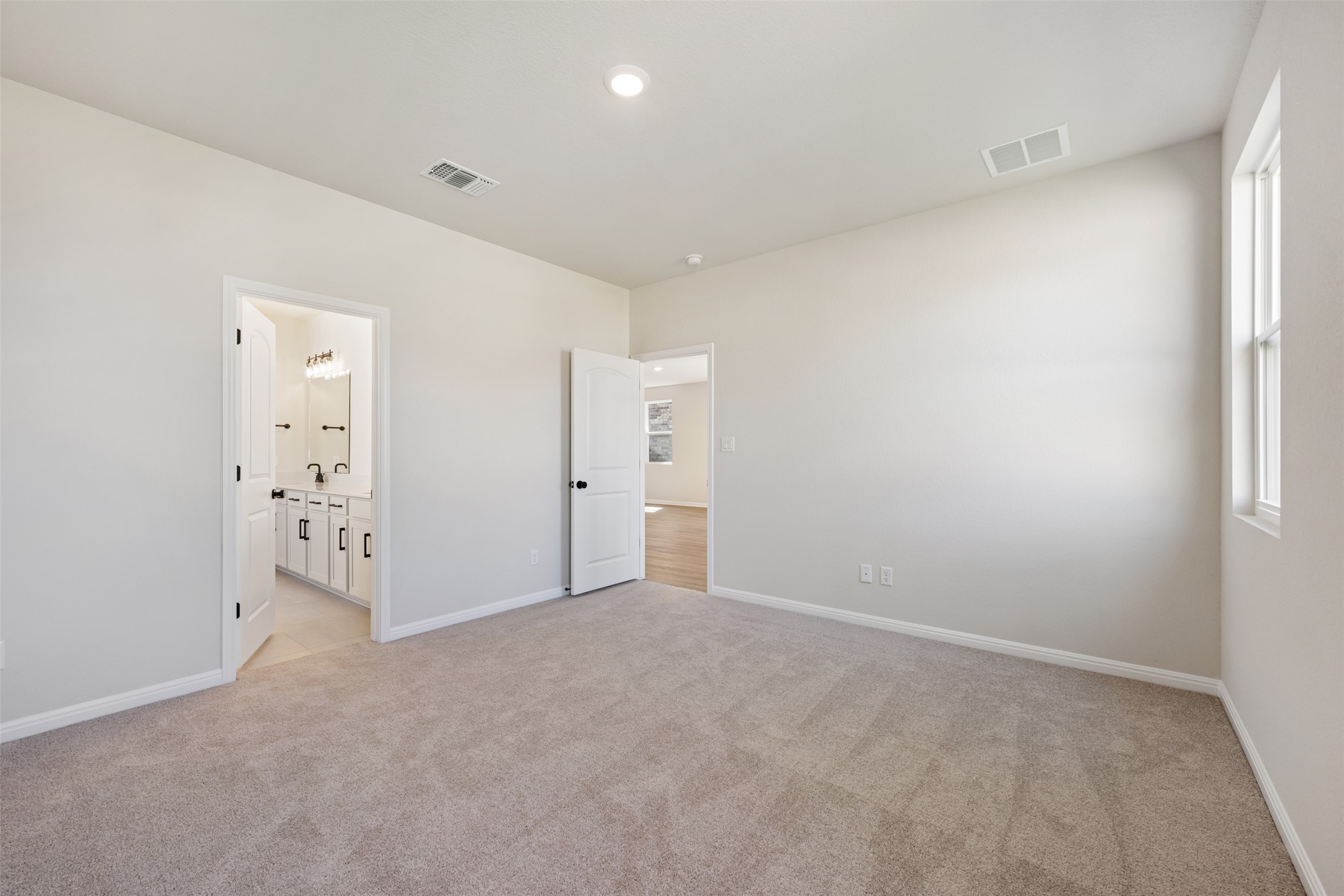 1036 Sienna Bear Road Georgetown, TX 78633 - Photo 9 of 33 an empty room with window and bathroom