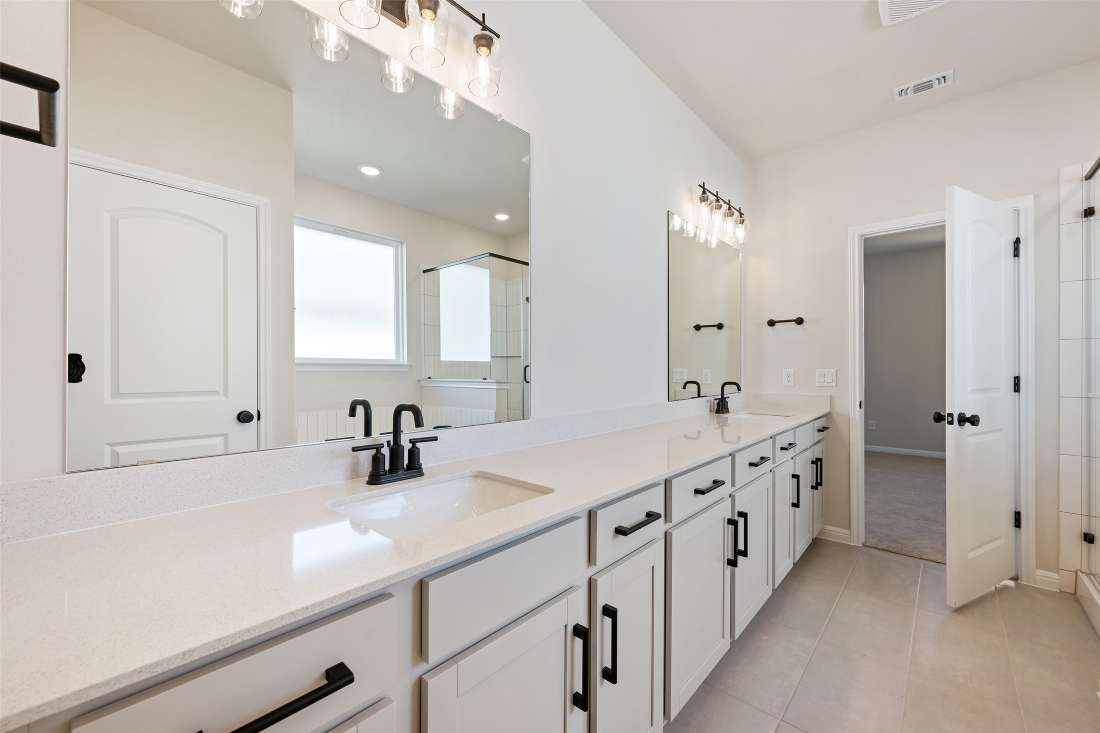 1036 Sienna Bear Road Georgetown, TX 78633 - Photo 10 of 33 a bathroom with double vanity sink and mirror