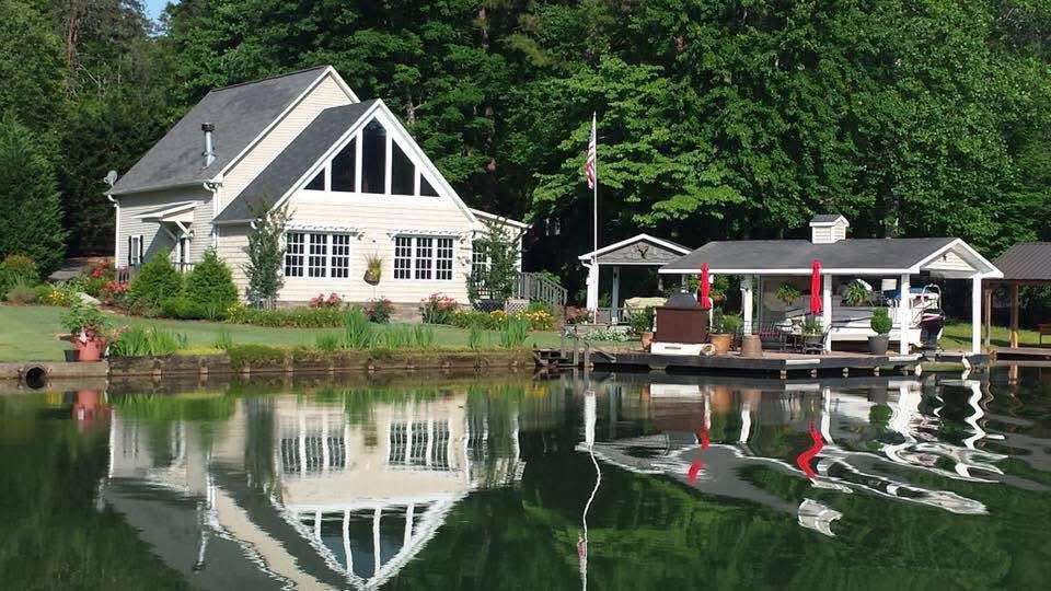 This charming lakeside dwelling offers picturesque waterfront views and a private boat dock for leisure.