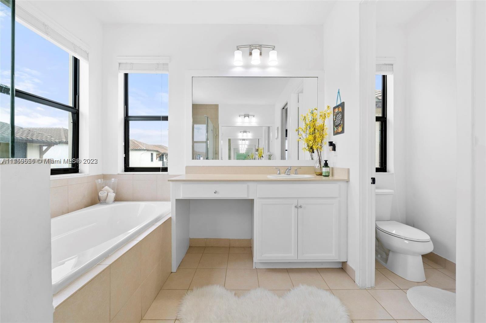 Hialeah Hialeah, FL 33018 - Photo 19 of 54 a bathroom with a sink a toilet and a large mirror