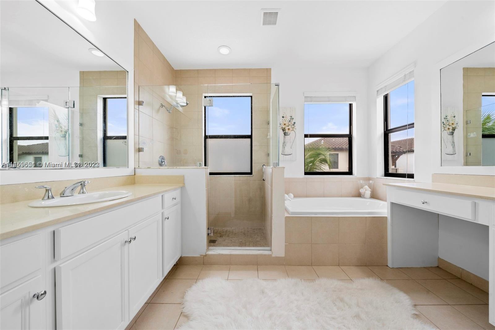 Hialeah Hialeah, FL 33018 - Photo 20 of 54 a spacious bathroom with a double vanity sink a mirror and a bathtub