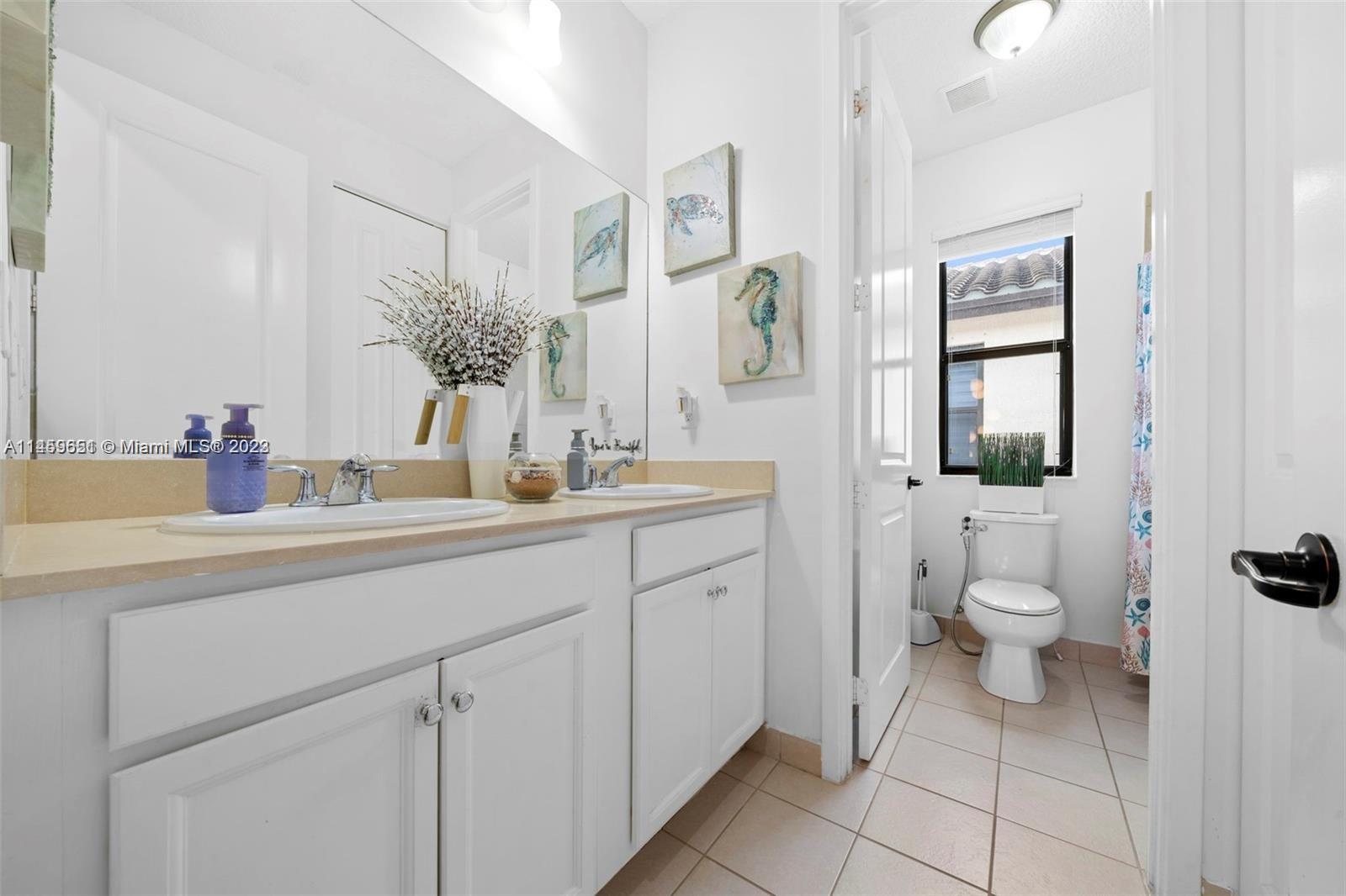 Hialeah Hialeah, FL 33018 - Photo 21 of 54 a bathroom with a toilet sink and mirror