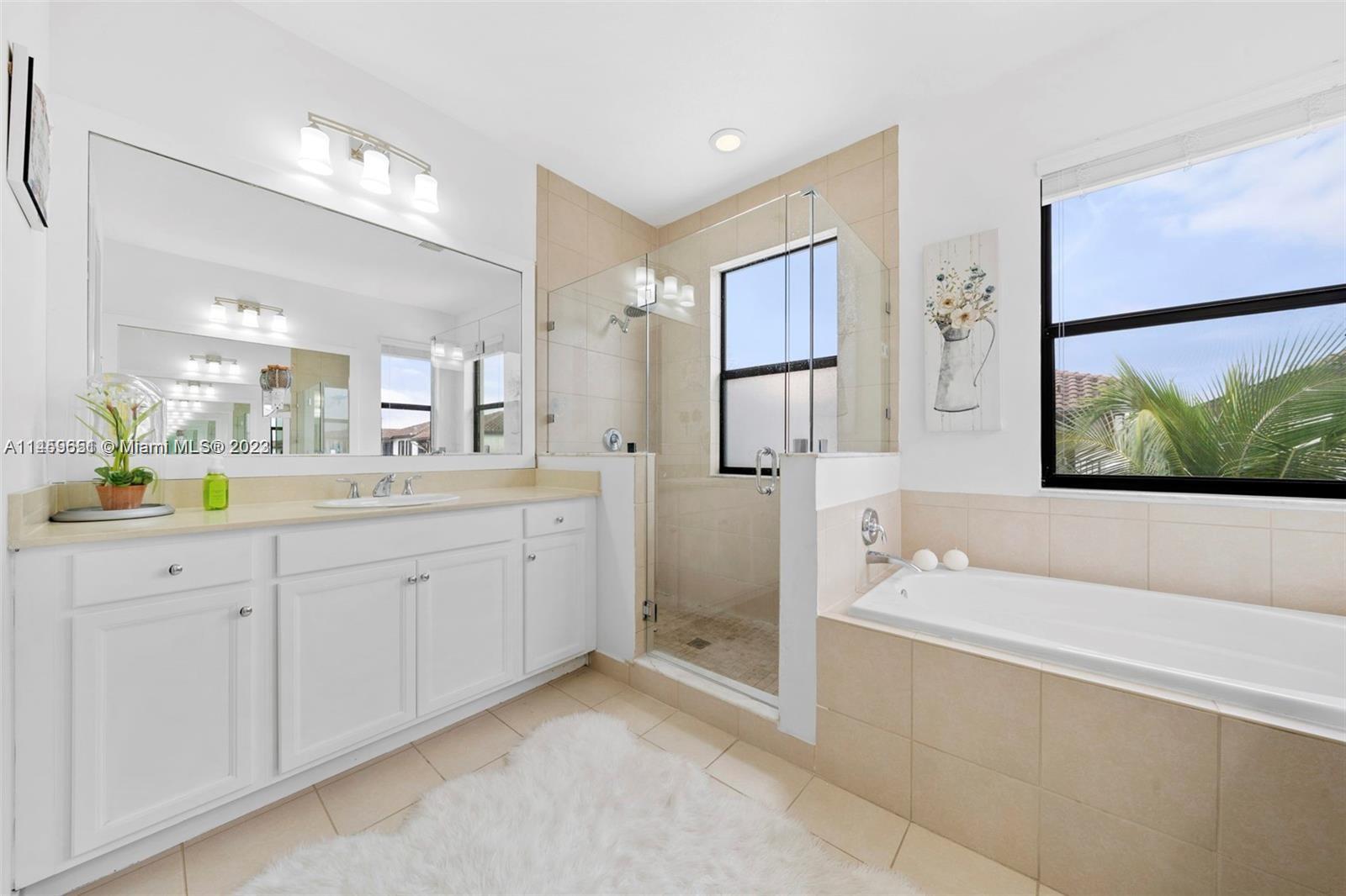 Hialeah Hialeah, FL 33018 - Photo 22 of 54 a spacious bathroom with a double vanity sink a mirror and a bathtub