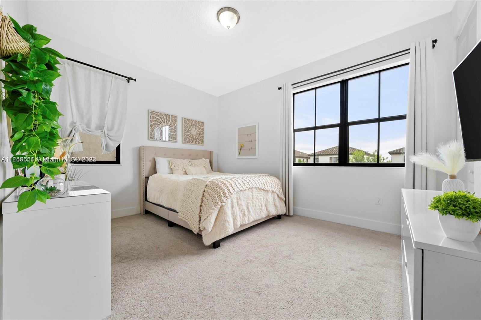 Hialeah Hialeah, FL 33018 - Photo 26 of 54 a bedroom with a bed potted plant on dresser next to a window