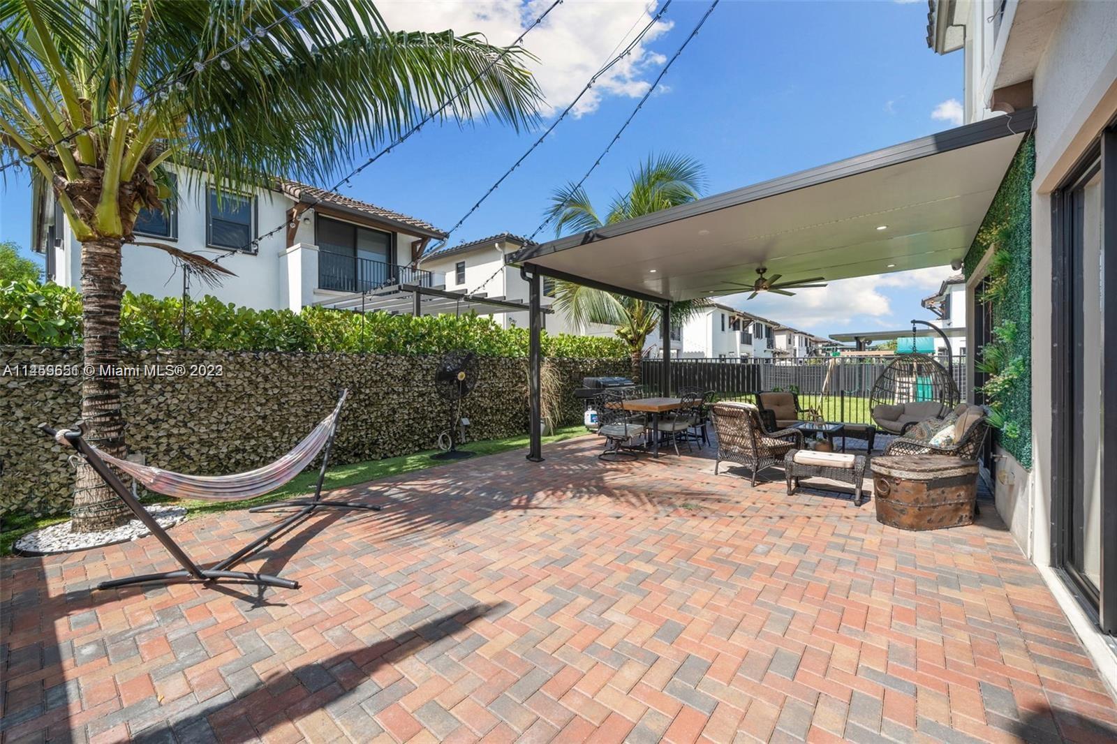 Hialeah Hialeah, FL 33018 - Photo 36 of 54 a view of a patio with table and chairs under an umbrella