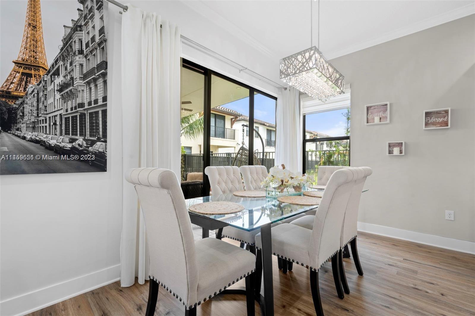 Hialeah Hialeah, FL 33018 - Photo 9 of 54 a view of a dining room with furniture a chandelier and wooden floor
