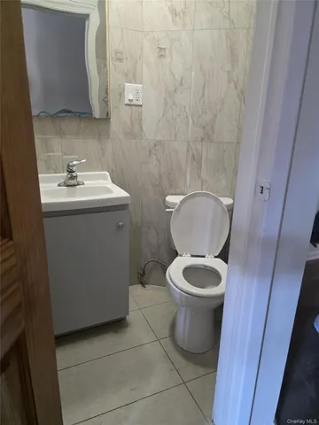 a white toilet sitting next to a bathroom sink